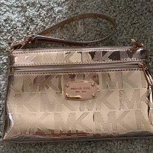 Michael Kors rose gold wristlet.